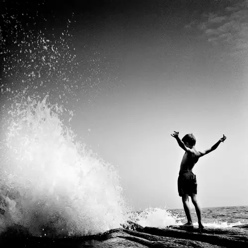 Boy in front of wave 