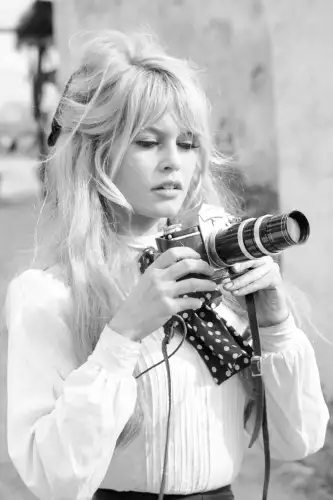 Bardot holds camera 