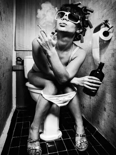 Girl on toilet with cigarette 
